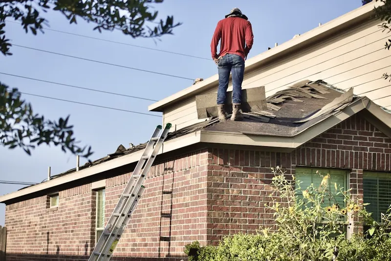 Professional roofer working on a residential roof in Nedrow